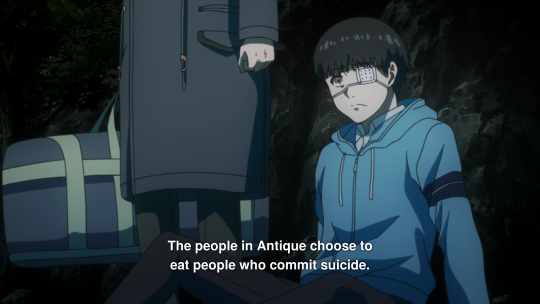 Kaneki, a thin Japanese boy in a blue coat and a white eyepatch, looks on nonplussed. A subtitle says 'The people in Antique choose to eat people who commit suicide'.
