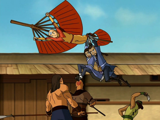 The main characters of Avatar take off in a glider, with a long narrow building behind them in messy perspective.