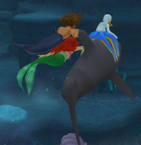 Sora, Donald and Ariel cling to a dolphin. Sora and Ariel hold on to the dorsal fin, while Donald just straddles his octopus legs across the dolphin's head.